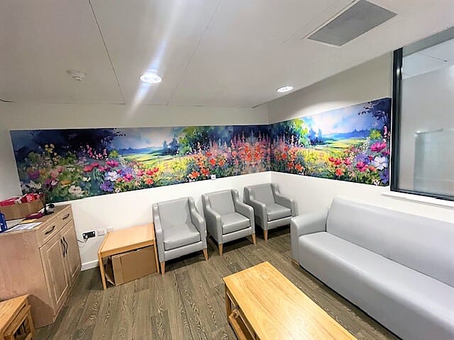 An image of a multi-colored floral wall graphic at NHS Sherwood Forest Hospital.